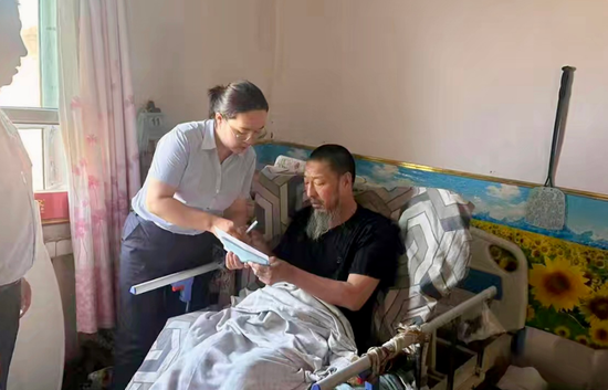 图为6月13日,哈巴河县农信社工作人员在加依勒玛村村民马海军家中办理密码挂失重置业务。雷晓刚 摄 图为6月13日,哈巴河县农信社工作人员在加依勒玛村村民马海军家中办理密码挂失重置业务。雷晓刚 摄