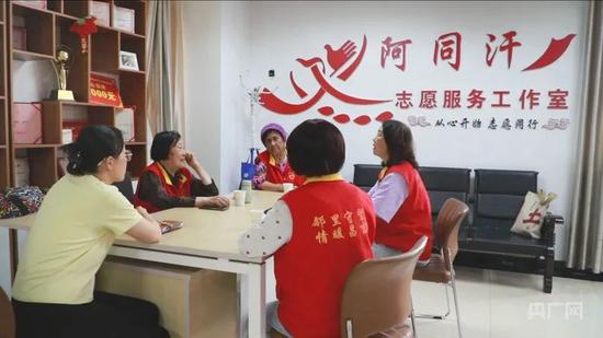 王桂珍(左二)在社区和志愿服务队讨论 (央广网记者丁安 摄)