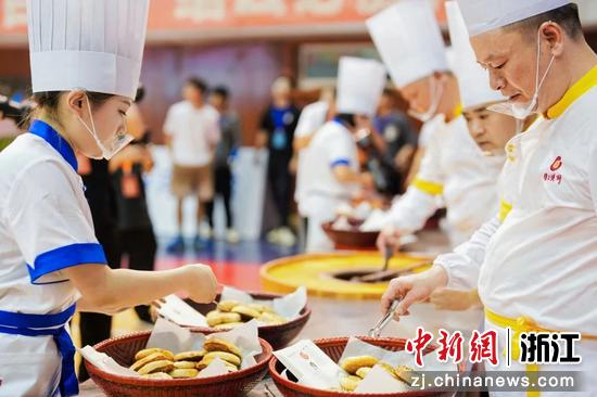 缙云烧饼师傅在比赛现场制作烧饼。 周勰 供图 缙云烧饼师傅在比赛现场制作烧饼。 周勰 供图