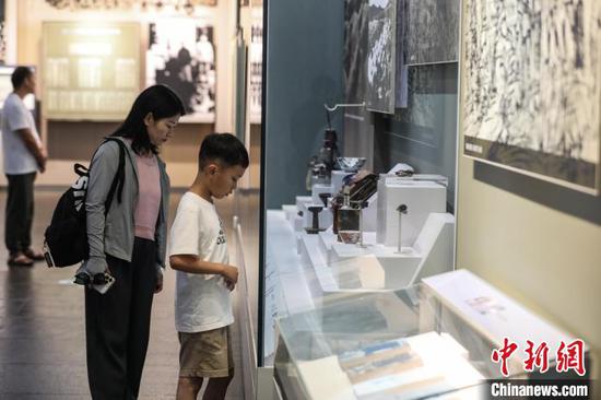 7月16日，游客在参观红军使用过的物品。暑假期间，位于贵州省遵义市红花岗区的遵义会议纪念馆游客络绎不绝。中新社记者 瞿宏伦 摄
