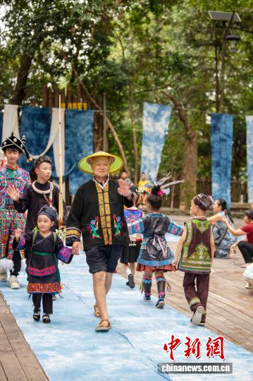 图为村民模特在岜沙苗寨的“村T”台上展示民族服饰。吴德军 摄