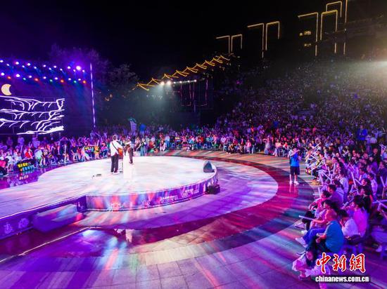 图为游客和市民在毕节市同心城市公园里观赏音乐季演出。罗大富 摄 图为游客和市民在毕节市同心城市公园里观赏音乐季演出。罗大富 摄