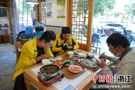 浙江南浔练市,外卖骑手在店内用餐。练市镇供图 浙江南浔练市,外卖骑手在店内用餐。练市镇供图