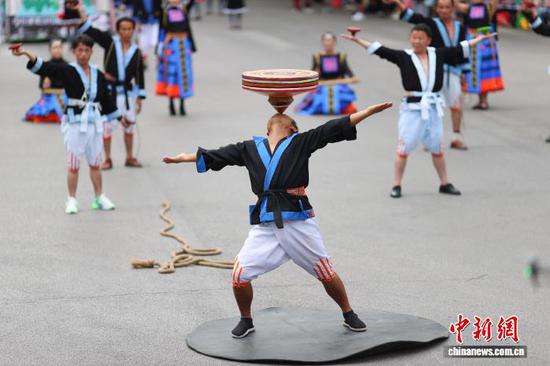 9月20日，身着传统服饰的民众在巡游展演中表演。 杨武魁 摄
