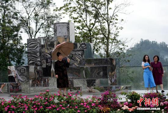 图为游客在《归乡·屯堡高台》前拍照打卡。石小杰 摄