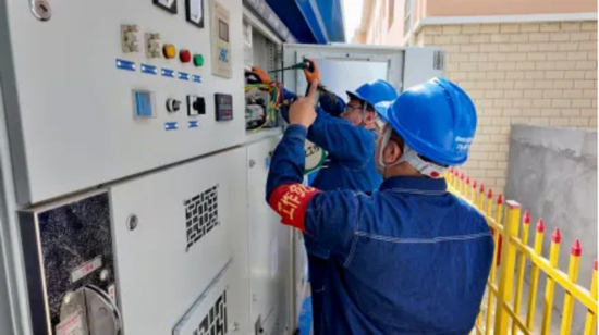 电力运维员打开配电箱，用仪器测线路温度，记录数据。