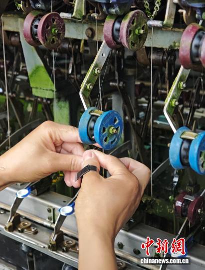 图为10月16日，工人在车间里进行缫丝工作。石小杰 摄