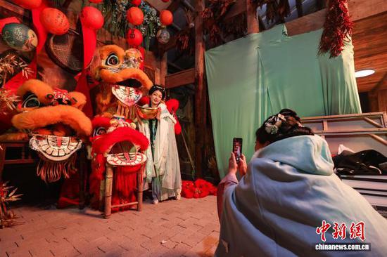 10月24日晚，市民在诗意田园·醒狮赋雅场景中和狮头合影。 记者 瞿宏伦 摄