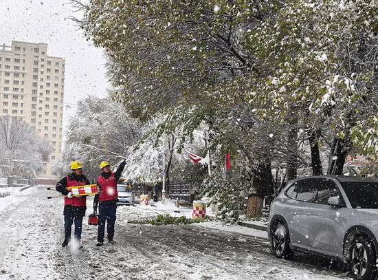 国网乌鲁木齐供电公司员工冒雪巡视城区供电线路。(李辉 摄) 国网乌鲁木齐供电公司员工冒雪巡视城区供电线路。(李辉 摄)