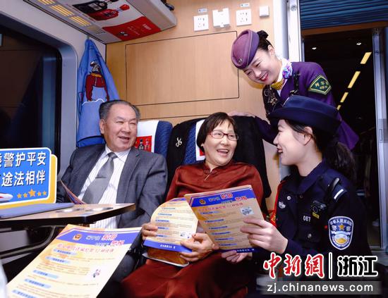 图为：乘警和列车长为旅客宣讲反诈知识。中新社发 贺瑞明 摄
