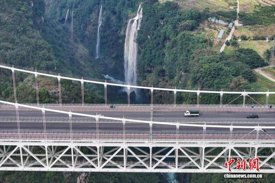 11月20日,航拍贵州兴义金州大桥和马岭河峡谷瀑布。金州大桥位于贵州省黔西南布依族苗族自治州兴义市,全长1600米,主跨450米,桥高235米。金州大桥将高桥技术与旅游体验相结合,依托跨越马岭河峡谷核心景区优势,创新打造了“桥上瞰山河、桥下观飞瀑”等为一体的桥旅新模式。(无人机照片)中新社记者 瞿宏伦 摄 11月20日,航拍贵州兴义金州大桥和马岭河峡谷瀑布。金州大桥位于贵州省黔西南布依族苗族自治州兴义市,全长1600米,主跨450米,桥高235米。金州大桥将高桥技术与旅游体验相结合,依托跨越马岭河峡谷核心景区优势,创新打造了“桥上瞰山河、桥下观飞瀑”等为一体的桥旅新模式。(无人机照片)中新社记者 瞿宏伦 摄