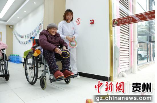 老人在参与趣味套圈游戏。 吴麟钦 摄 老人在参与趣味套圈游戏。 吴麟钦 摄