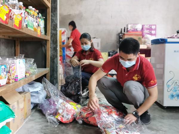 图为百色烟草员工为客户整理货架陈列。王筱萍 摄