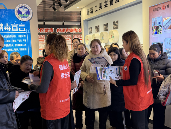 工作人员向妇联干部妇女儿童群体讲解禁毒反诈知识。