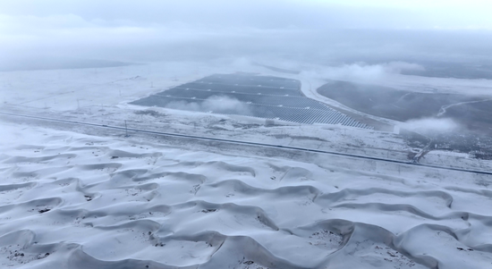 皑皑白雪覆盖广袤沙海。阿巴拜科日摄