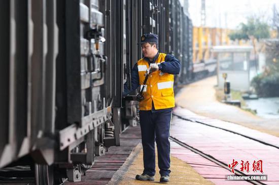 2月9日，调车组工作人员在进行提钩作业。中新社记者 瞿宏伦 摄