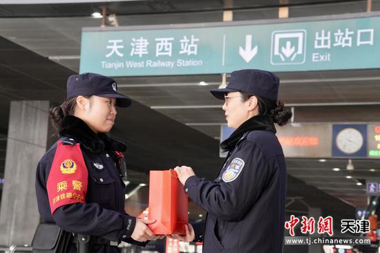 图为春节前,齐玮向乘警发放慰问品,并嘱咐乘警值乘的相关注意事项。(北京铁路公安局天津公安处供图)