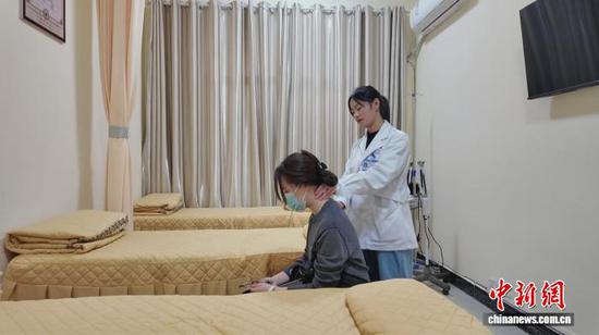 图为莫明仙为患者进行中医推拿。曾浩洋 摄