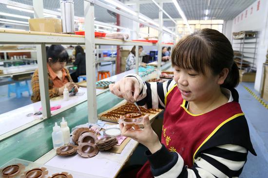 香凤协作共建就业基地。工人在凤冈县龙泉街道凤翔社区的扶贫车间生产扬声器配件音圈。饶云  摄