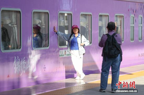 图为旅客在多彩贵州号旅游专列开行前打卡拍照。
