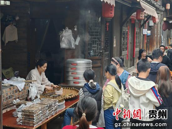 土城古镇手工小吃摊位的游客。习水县融媒体中心供图