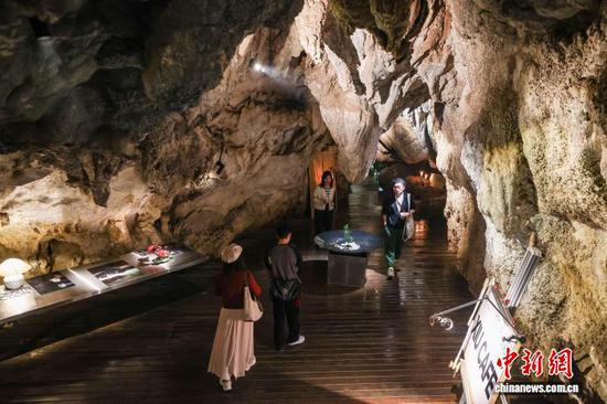 5月10日，贵州省贵阳市，游客在修文县香巴湖村的一家“洞穴咖啡馆”内游览。该“洞穴咖啡馆”依托当地天然喀斯特溶洞于2025年8月改造而成，施工时在不破坏原始地质风貌的前提下，搭配简约软装与暖调灯光，将自然溶洞景观与休闲咖啡业态相融。目前，“洞穴咖啡馆”已成为网红打卡地，吸引着各地游客慕名而来。中新社记者 瞿宏伦 摄
