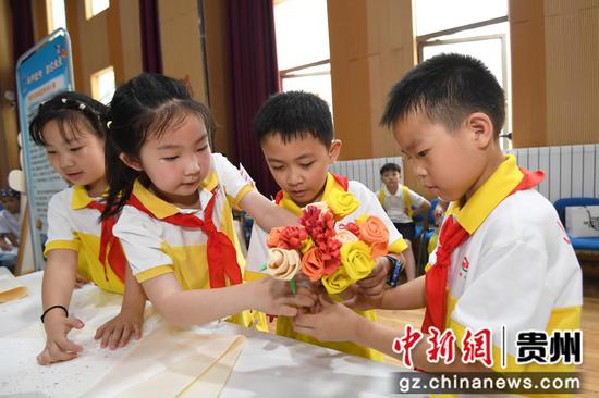 6月5日，贵阳市南明区甲秀小学的学生正在劳动教育实践技能展演活动现场制作爱心花束。