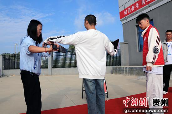 6月7日，在威宁自治县第七中学考点，宫典通过安检进入考场。彭凯 摄