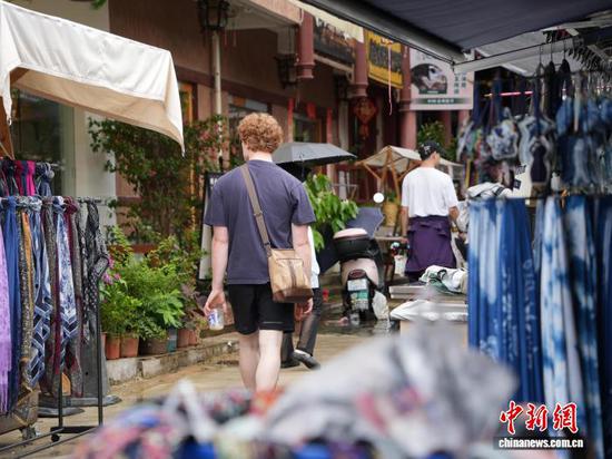 7月4日,贵州省凯里市苗侗风情园内,游客在逛绣里淘非遗集市。中新社记者 周燕玲 摄 7月4日,贵州省凯里市苗侗风情园内,游客在逛绣里淘非遗集市。中新社记者 周燕玲 摄