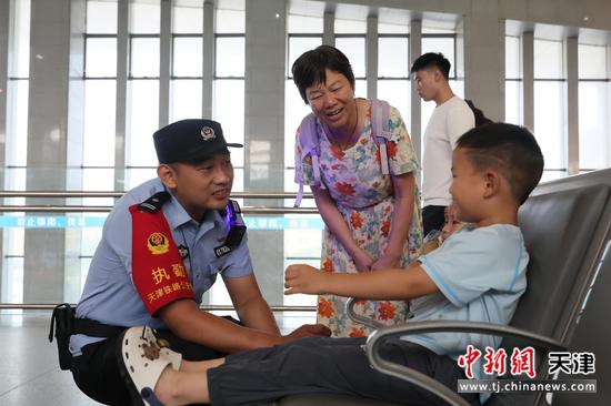 图为北京铁路公安局天津公安处执勤民警正在候车大厅执勤巡逻,与小朋友热情交谈。(北京铁路公安局天津公安处供图) 图为北京铁路公安局天津公安处执勤民警正在候车大厅执勤巡逻,与小朋友热情交谈。(北京铁路公安局天津公安处供图)