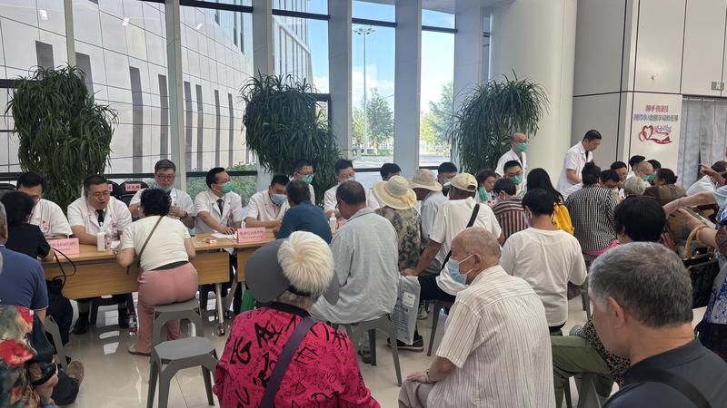 7月25日，义诊现场，上海援疆医疗骨干们正在接诊患者。