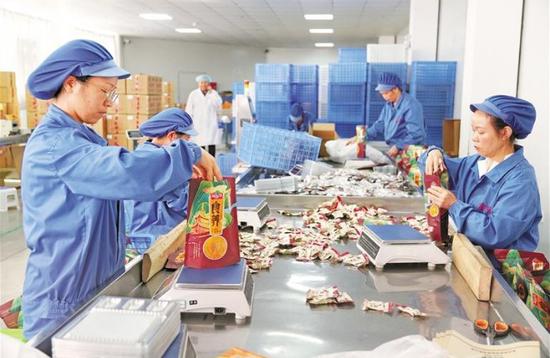 贵州高原颂食品有限公司工人正在称重包装牛肉制品。 本报记者 杨曦 摄