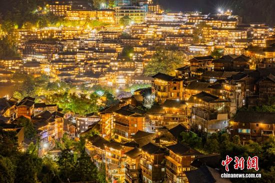 西江千户苗寨，夜景璀璨，犹如一幅流光溢彩的画卷在大山里舒展开来，吸引各地游客前来观赏。