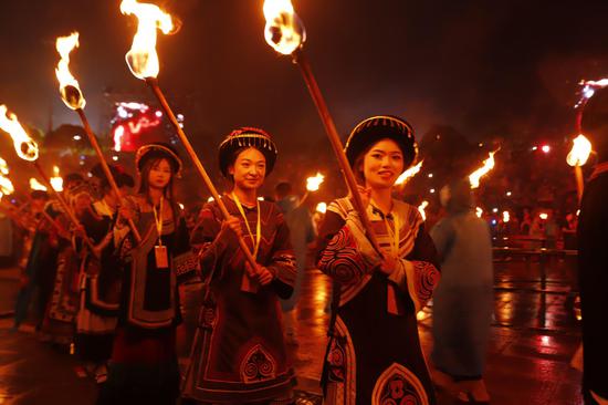 游客参与绕火祈福。朱芸 摄 游客参与绕火祈福。朱芸 摄