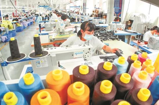 大方经开区贵州美邦服饰科技有限公司羽绒服车间内机器轰鸣、工序流转，工人们赶制着手中订单。 本报记者 郑宇潇 摄