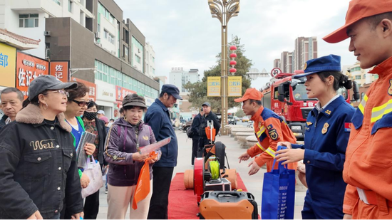 消防宣传员面向群众对消防知识答疑解惑。向欣欣摄