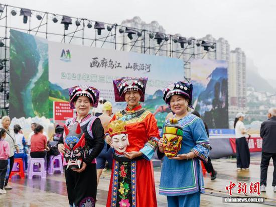 图为当地民众在比赛现场展示手工雕刻的傩面具。杜鑫 摄