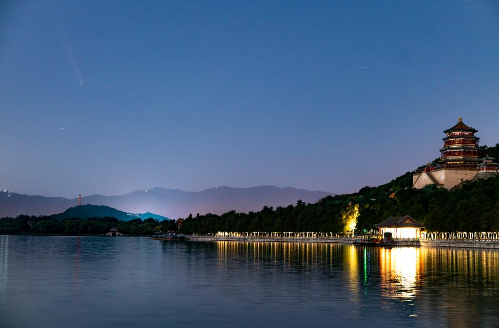 Comet streaks through night sky over Summer Palace