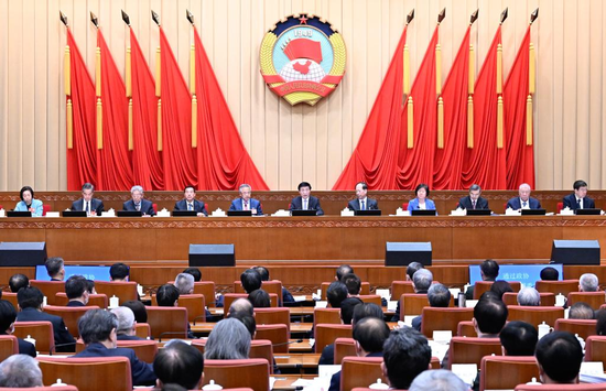 Wang Huning, a member of the Standing Committee of the Political Bureau of the Communist Party of China Central Committee, presides over the third meeting of the presidium of the first session of the 14th National Committee of the Chinese People's Political Consultative Conference (CPPCC) in Beijing, capital of China, March 9, 2023. (Xinhua/Shen Hong)