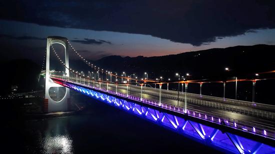 Lighting adds nocturnal glint to bridge on Yangtze River in Chongqing