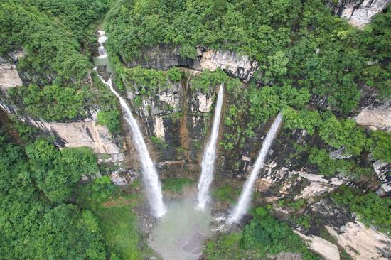 Triple waterfalls cascade down mountain in Guizhou