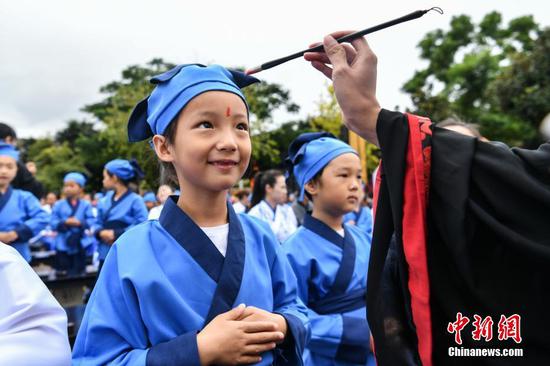 File photo of children performed the Confucious ritual at a 