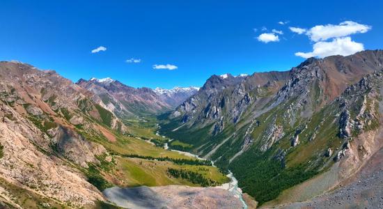 Crystal-clear river meanders through valleys of Tianshan mountains