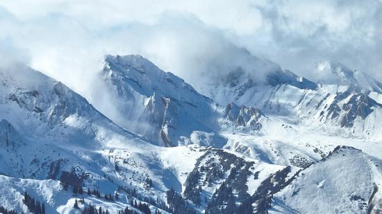 Snow-capped mountain with sea of clouds in Xinjiang