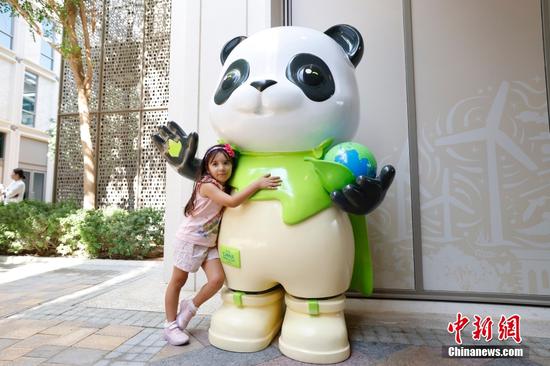 Eye-catching panda mascot at COP28 draws visitors