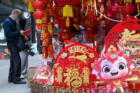 People shop decorations ahead of Spring Festival in Guangzhou