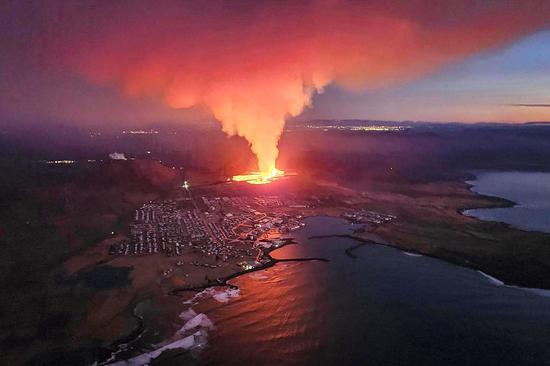 Volcano eruption spills lava into town in Iceland