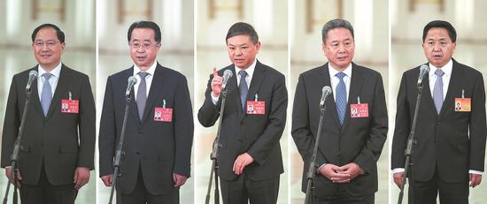 Five ministerial-level officials (from left) Jin Zhuanglong, Lu Zhiyuan, Huang Runqiu, Li Xiaopeng and Luo Wen answer questions after the plenary meeting of the National People's Congress at the Great Hall of the People in Beijing on Friday. (KUANG LINHUA/CHINA DAILY)