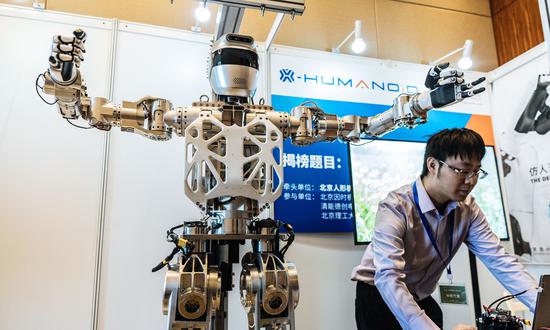 Researcher tests a robot at the exhibition site of a humanoid robot competition on March 13, 2024. (Photo: Li Hao/GT)