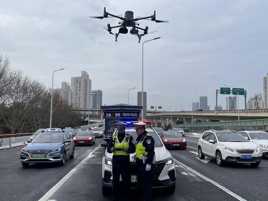 Two Shanghai traffic police officers get a UAV ready for traffic patrol in Shanghai. (Photo provided to chinadaily.com.cn)